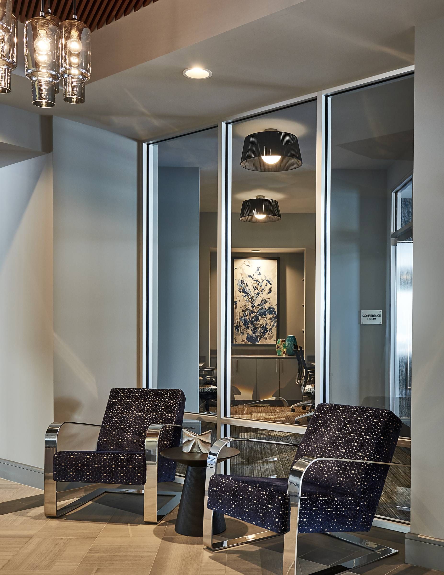 Evolution at Towne Center Laurel clubhouse lounge area with modern arm chairs and chandelier.