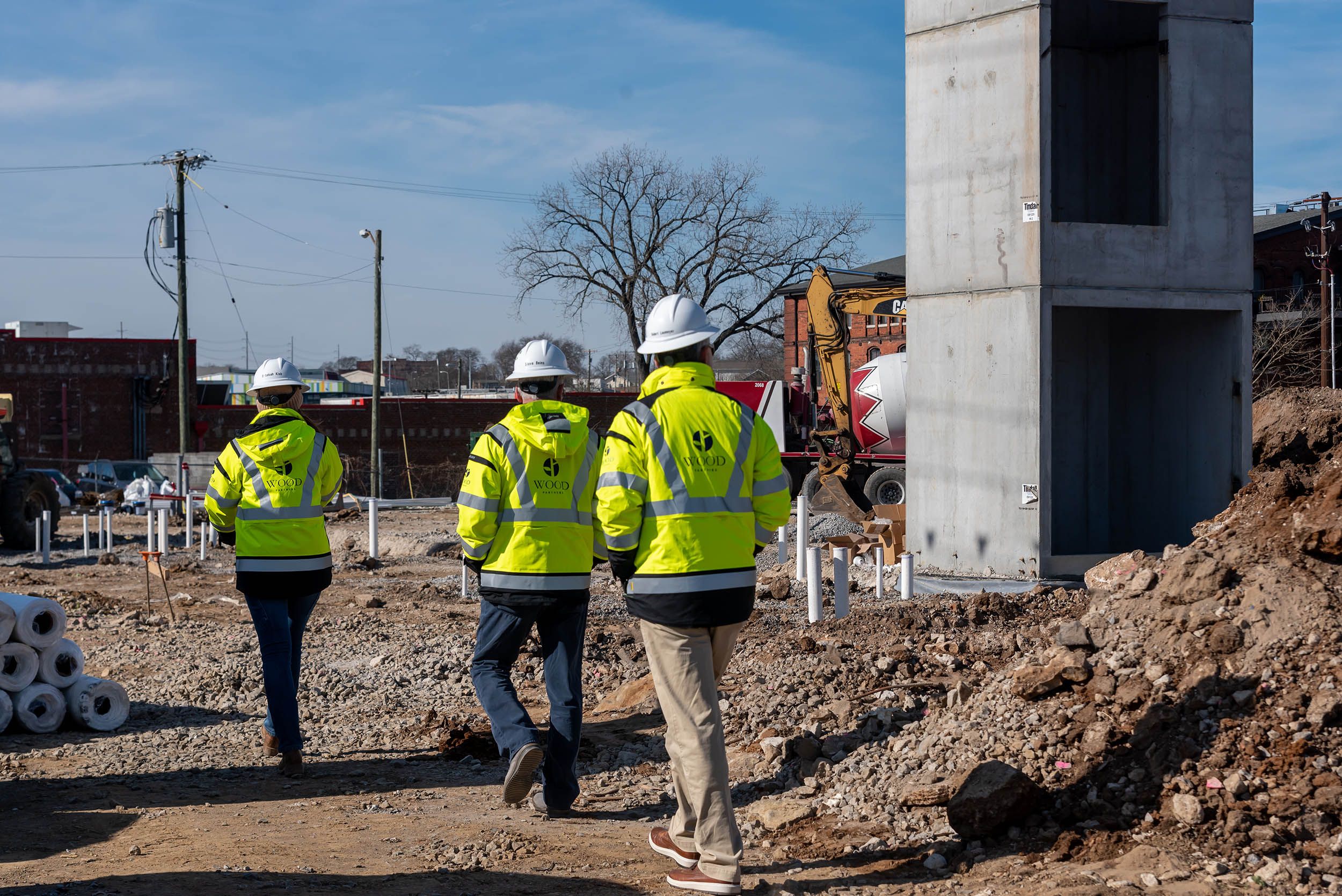 Construction workers walk towards a construction site.