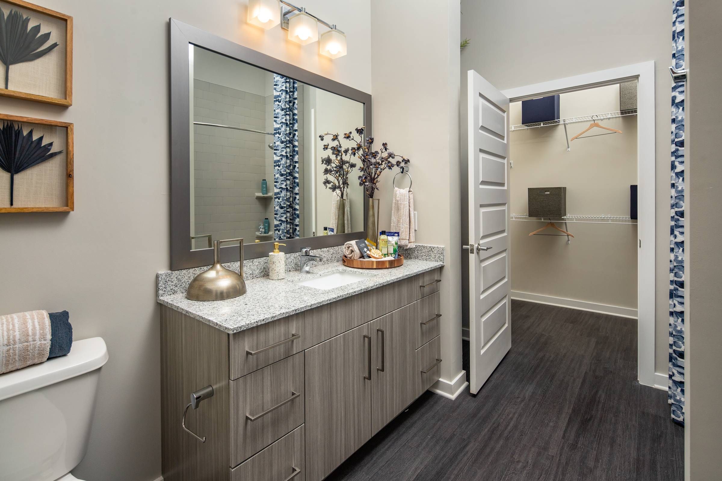 The bathroom at Alta Sugarloaf shows a large mirror, under-mount sink, and ample cabinetry, with a walk-in closet visible in the background.