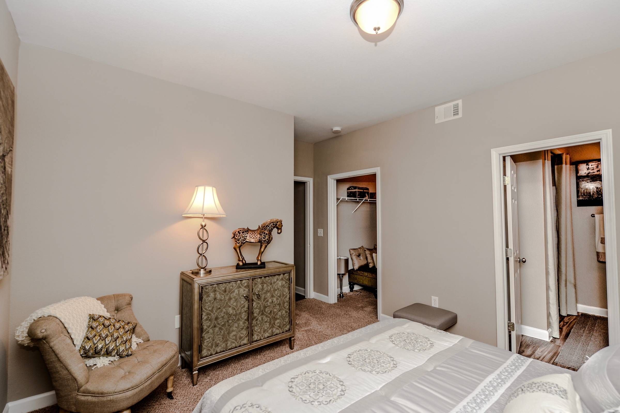 Altera Riverside bedroom with carpet floor, private bathroom, and walk-in closet.