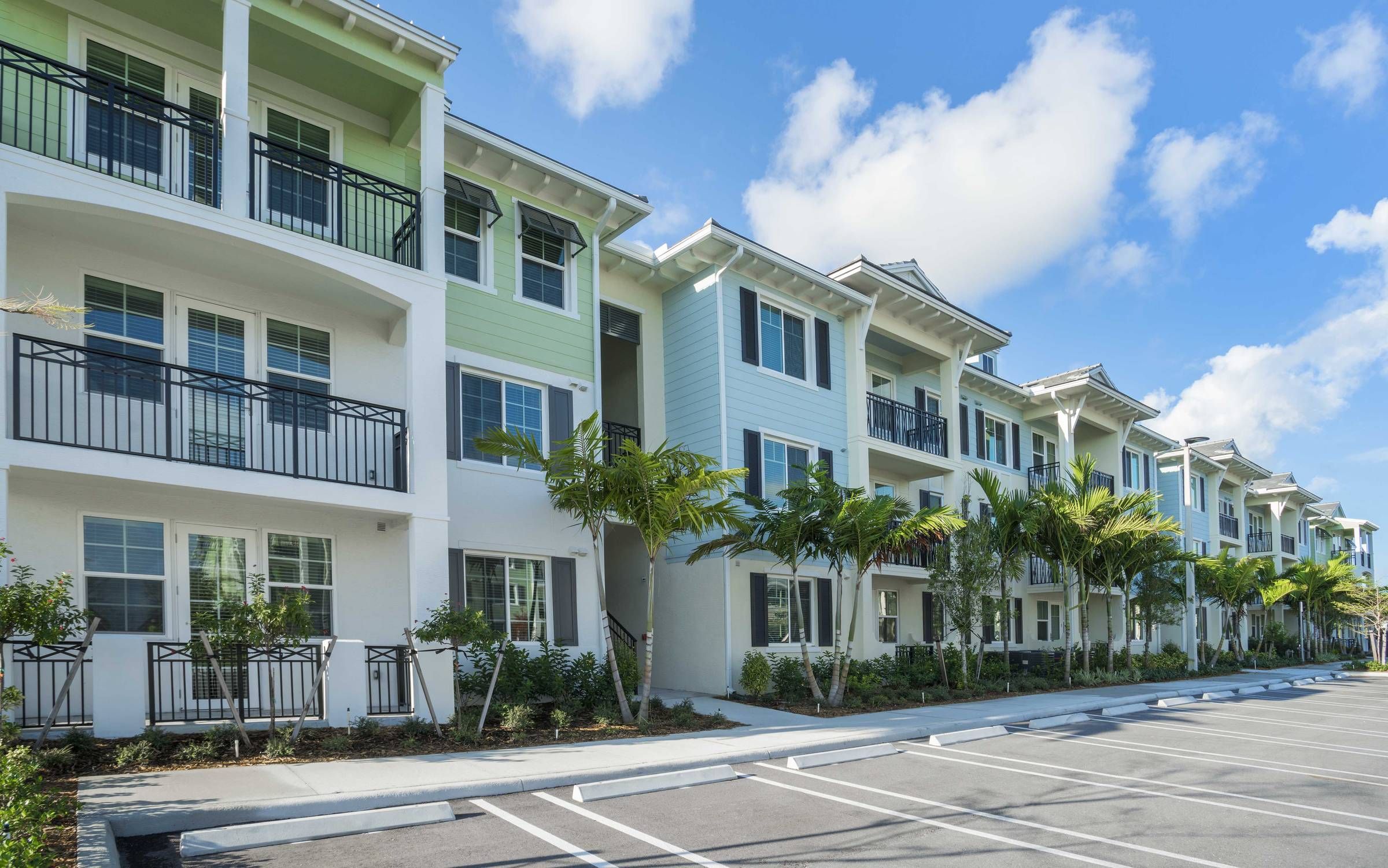 Delray Station apartment complex exterior with pastel-colored paint and beachy architecture.