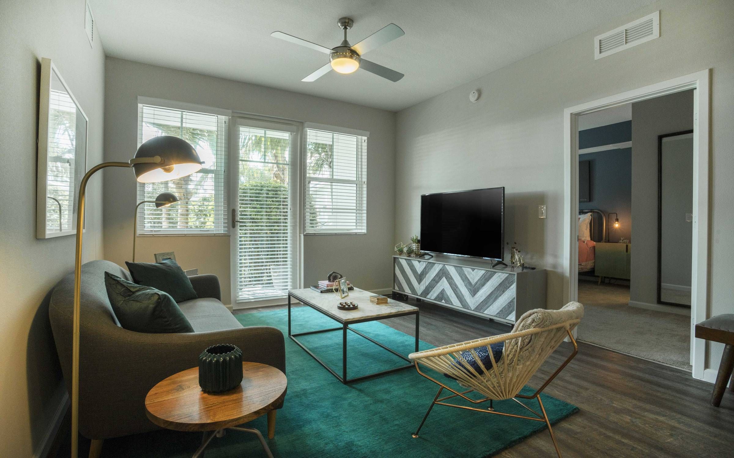 Delray Station living room with windows and hardwood floor.