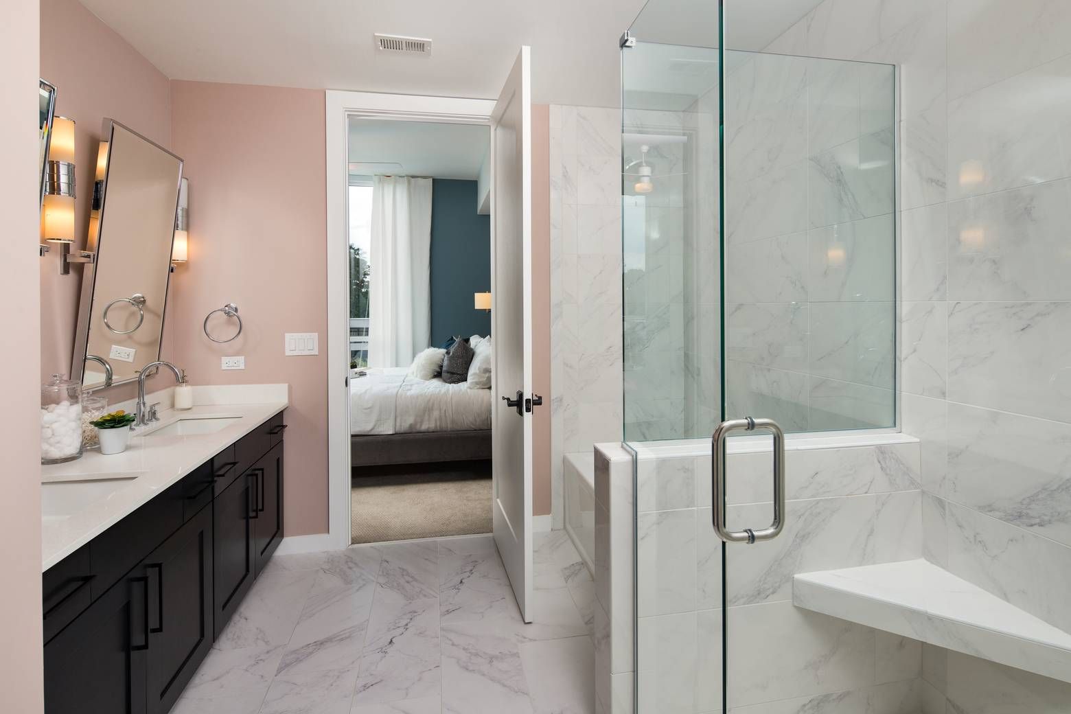 The Huntley en-suite bathroom with double sink with large mirrors, and a large marble glass-door shower.