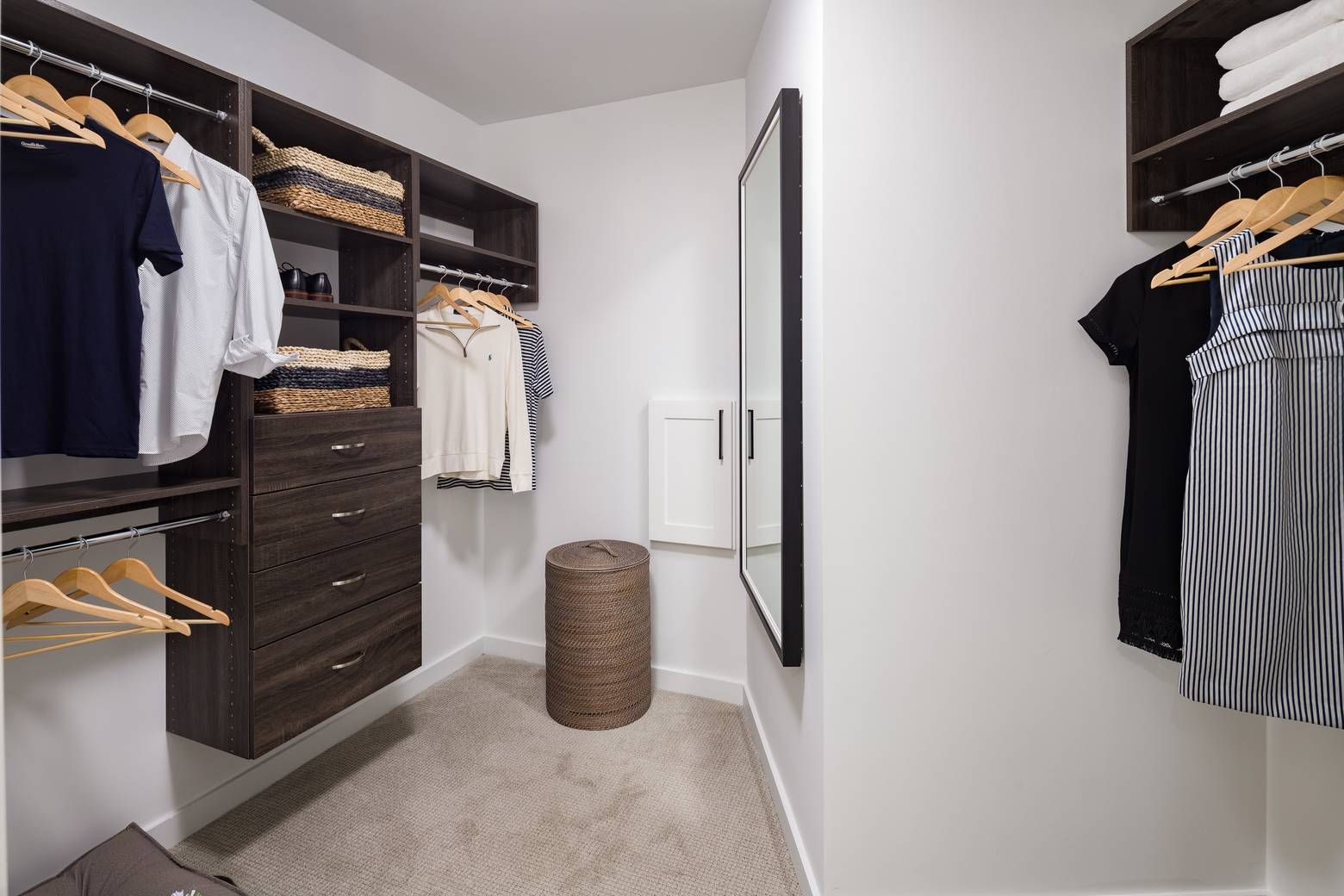 The Huntley large walk-in closet with built-in storage unit.
