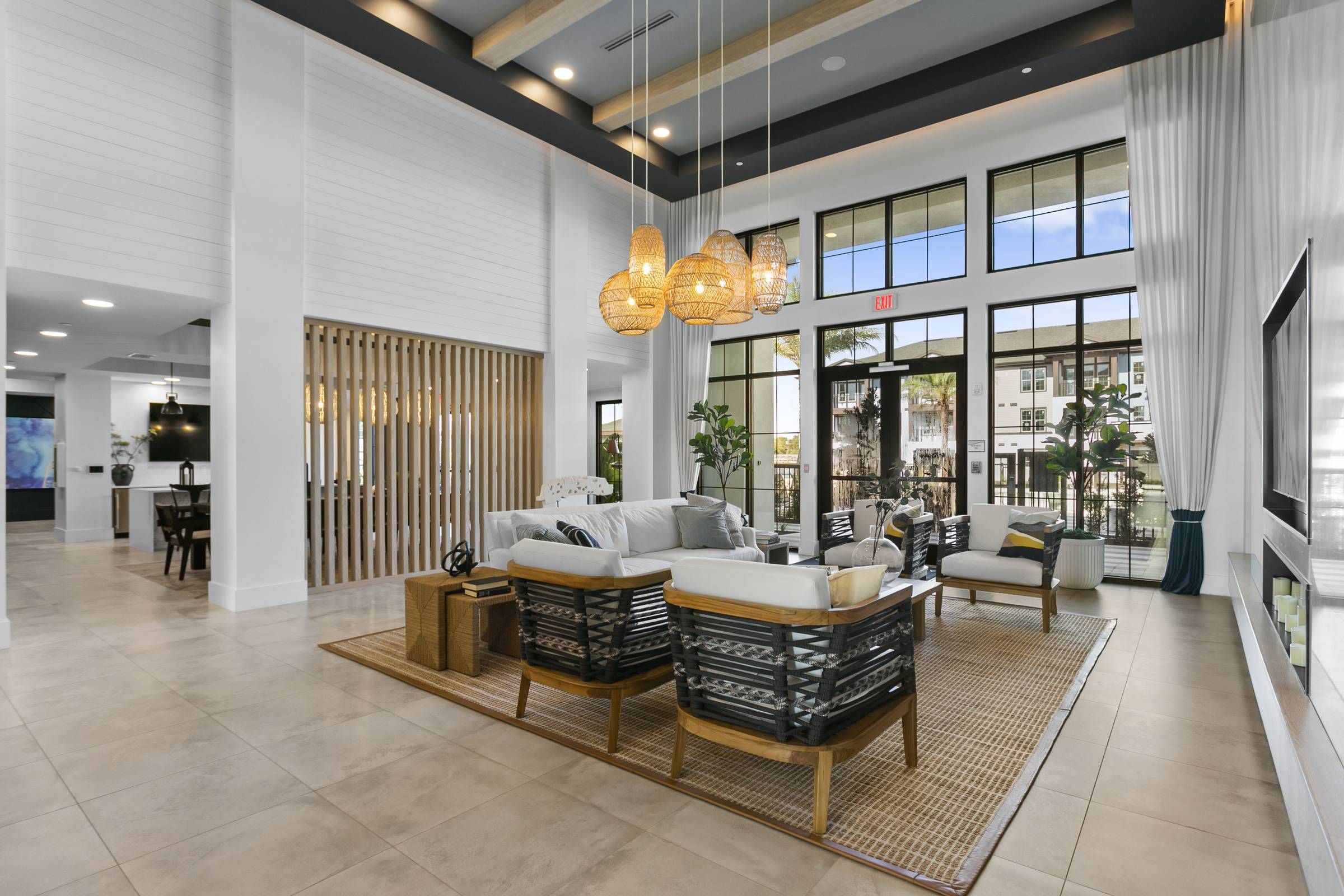 A grand entrance lobby at Alta Clearwater with high ceilings, elegant seating, and a wall of windows.