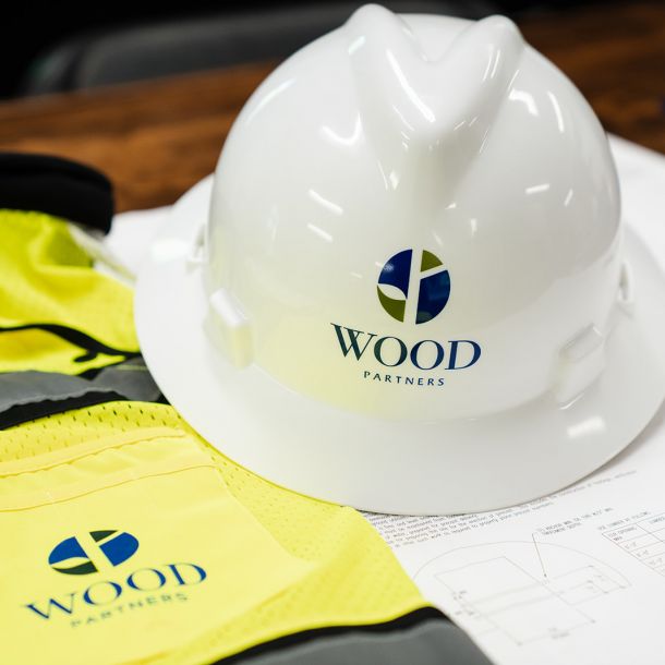 Brown hard hat on top of Wood Partners construction vest