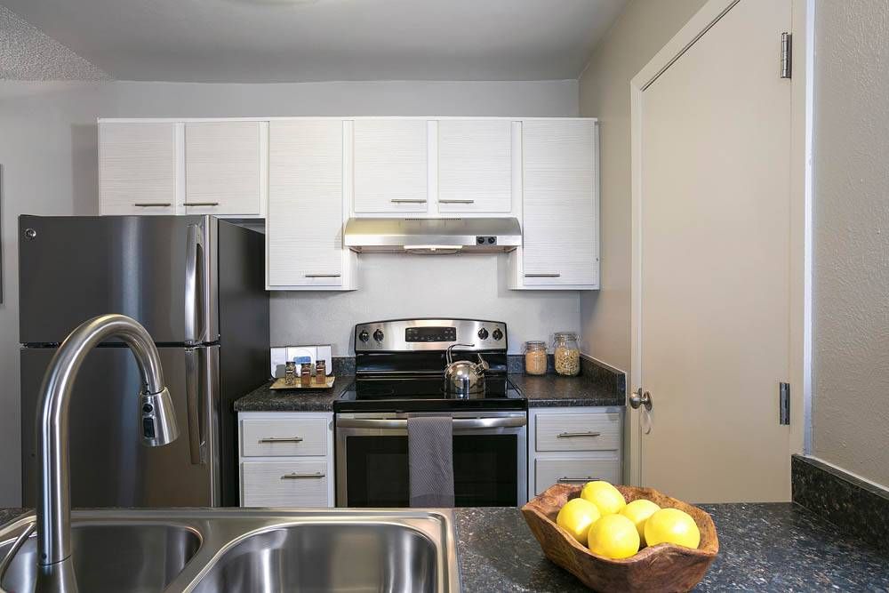 The Grove at City Center kitchen with stainless steel appliances, and granite countertop.