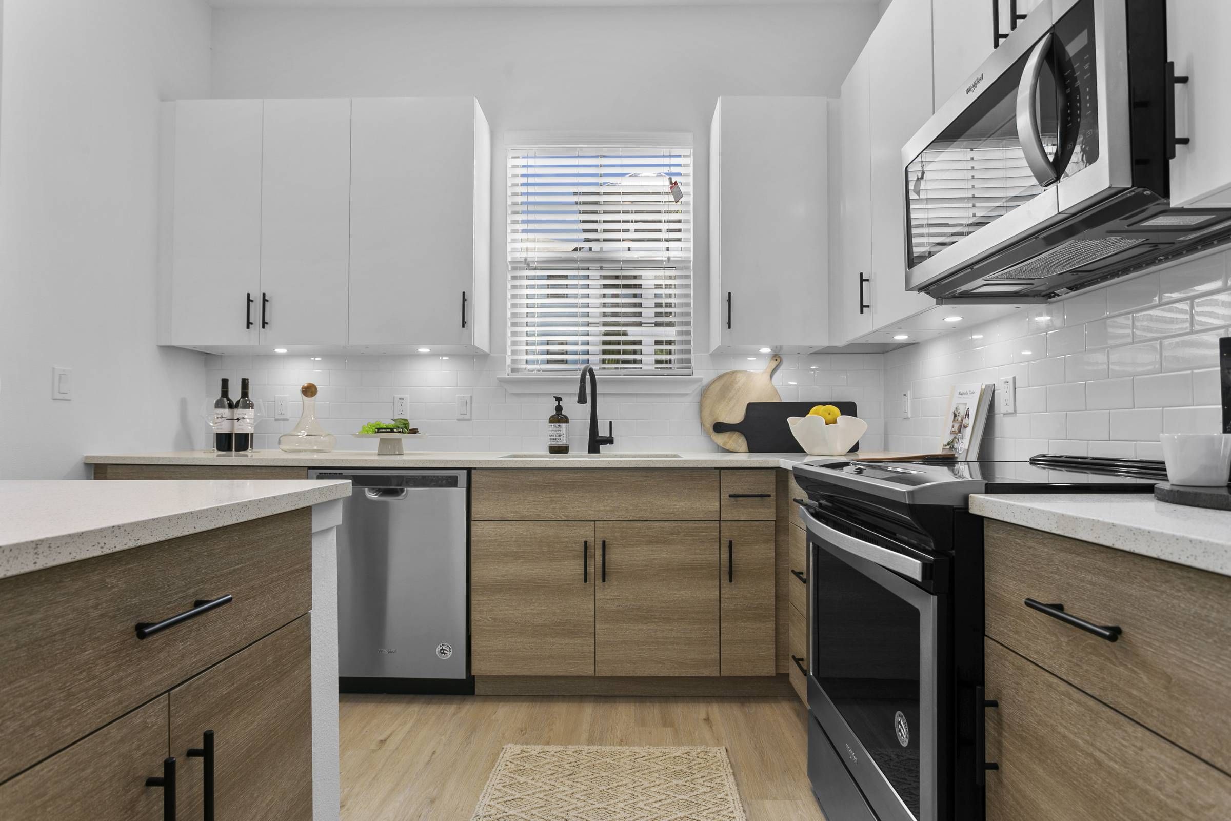 A well-lit kitchen with sleek cabinetry and stainless steel appliances at Alta Clearwater.