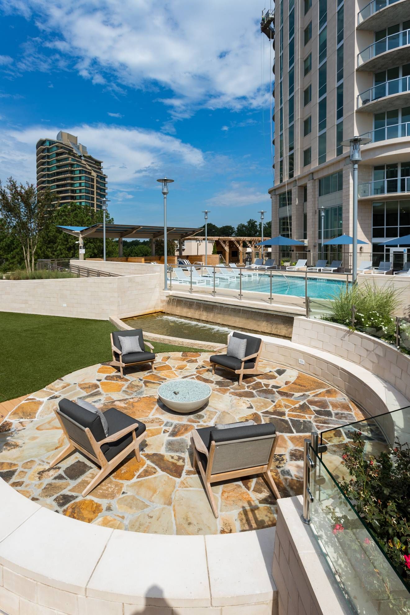 The Huntley outdoor fire pit area with lounge chairs and beautiful tile.