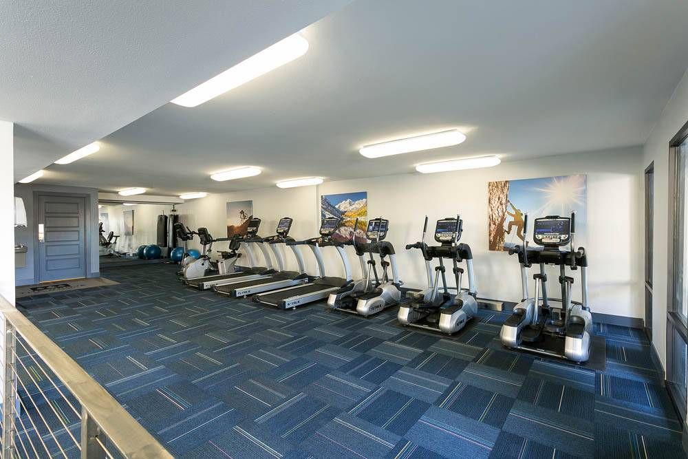 The Grove at City Center fitness center with ellipticals and other workout equipment.