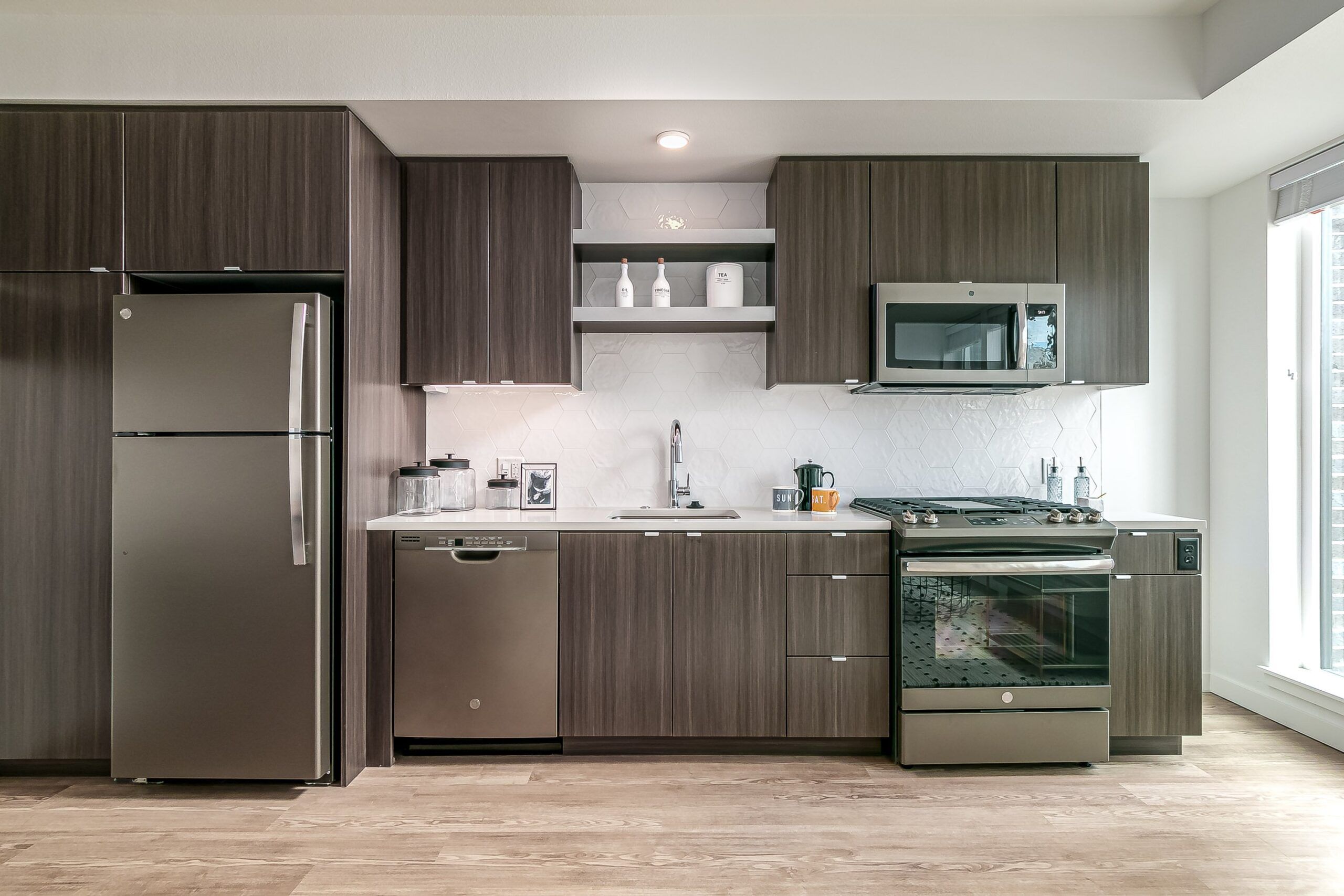 Alta Peak apartments kitchen interior with stainless steel appliances and wood cabinetry