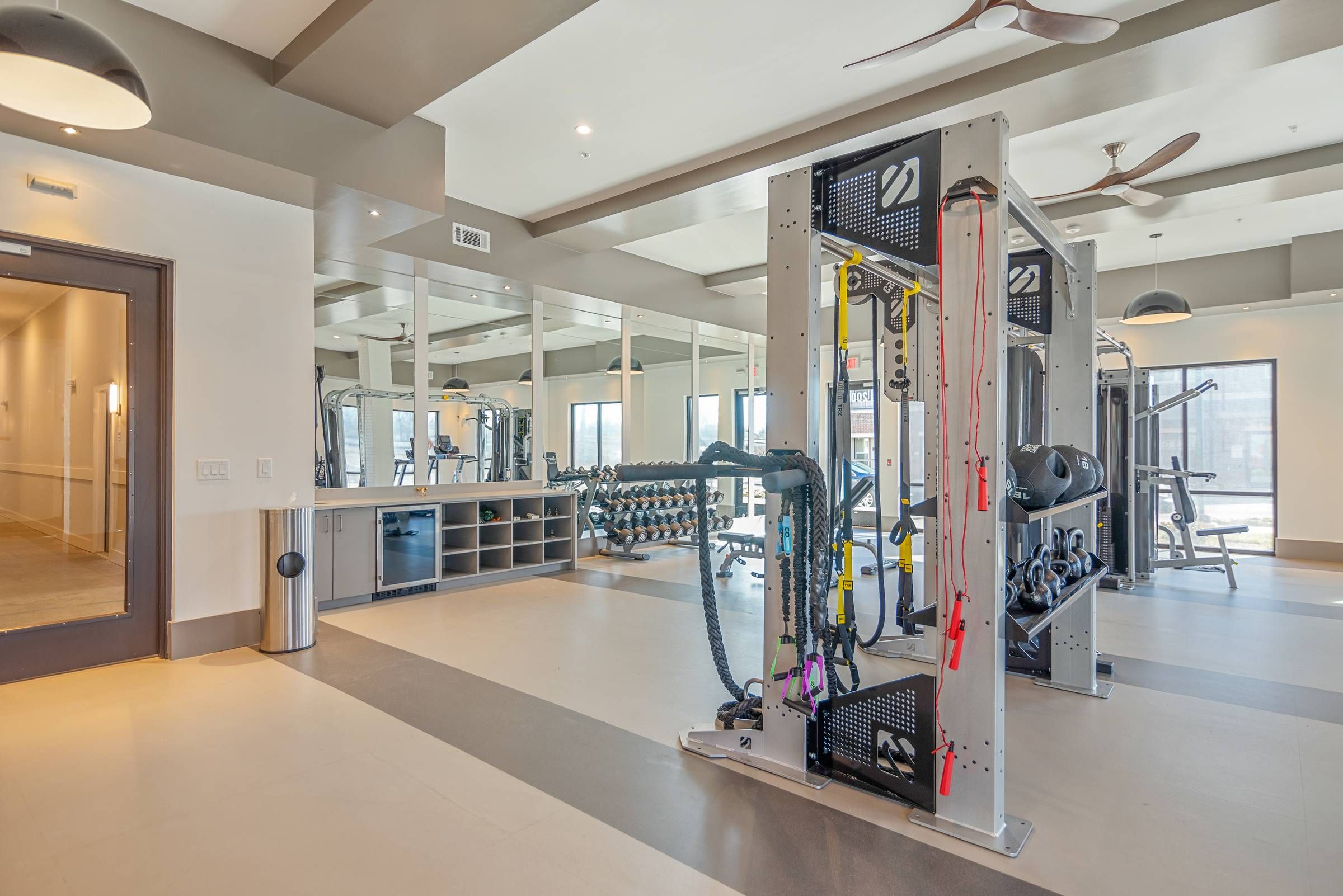 Alta Depot gym room with various exercise equipment and mirrors for fitness enthusiasts to work out and monitor their form.