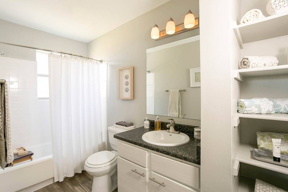 The Grove at City Center full bathroom with sink, toilet, shower/bath, and large linen closet..