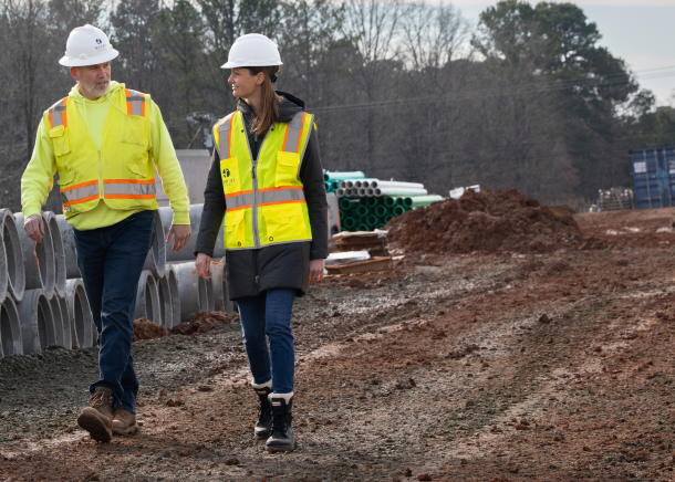 Aerial view of construction team looking at a set of blueprints