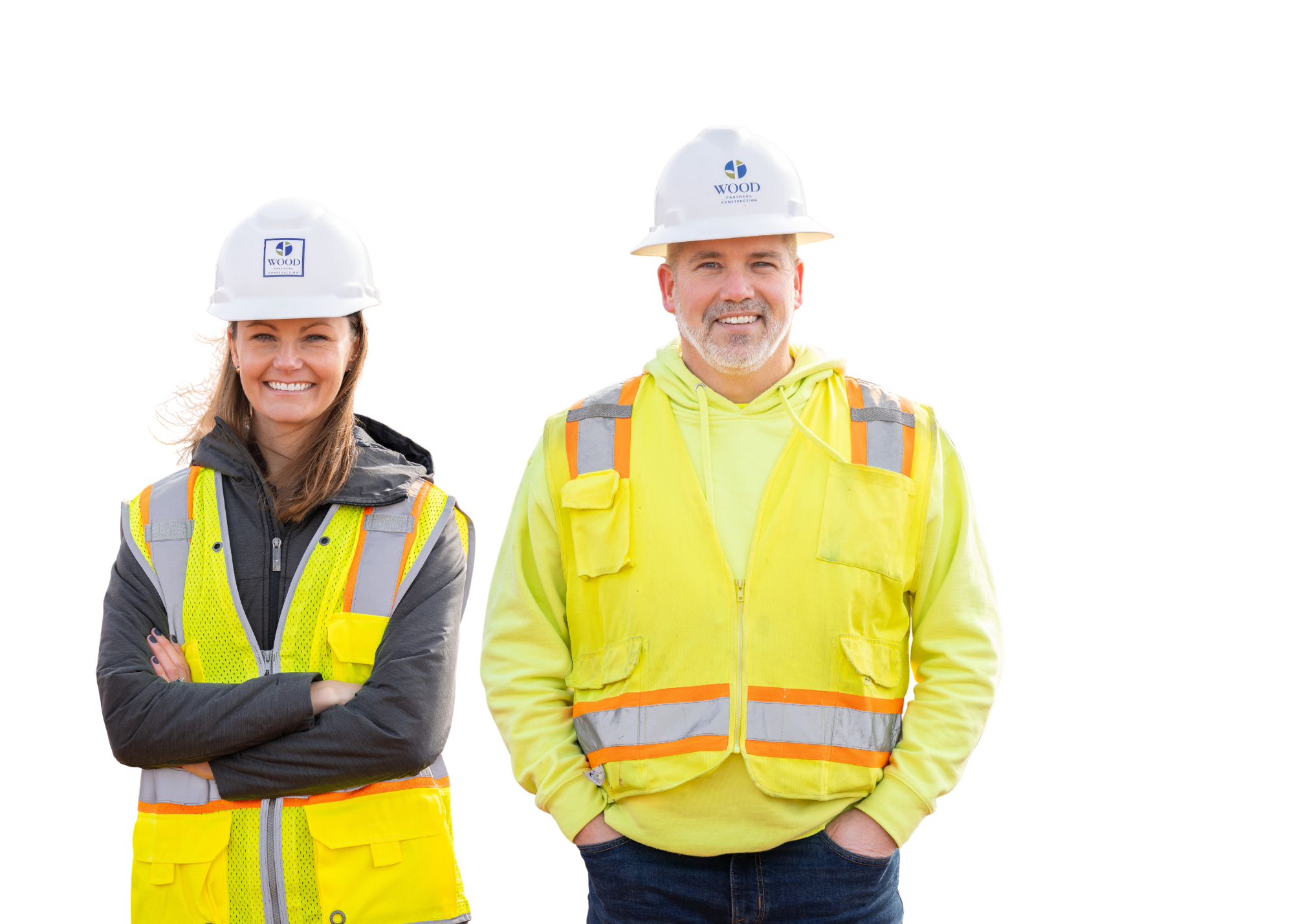 Two construction workers in yellow safety vests and hard hats standing and smiling against a white background.
