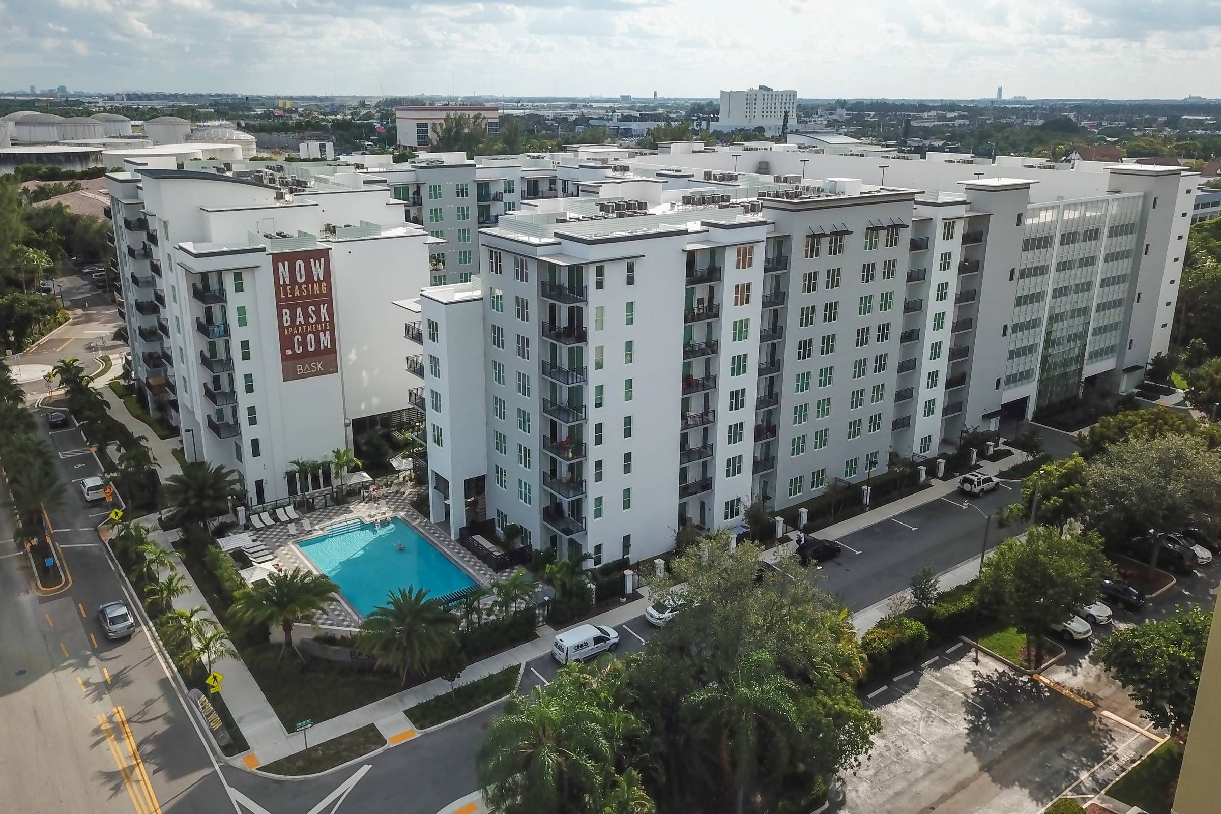 Bask aerial view of apartment complex with view of the pool.