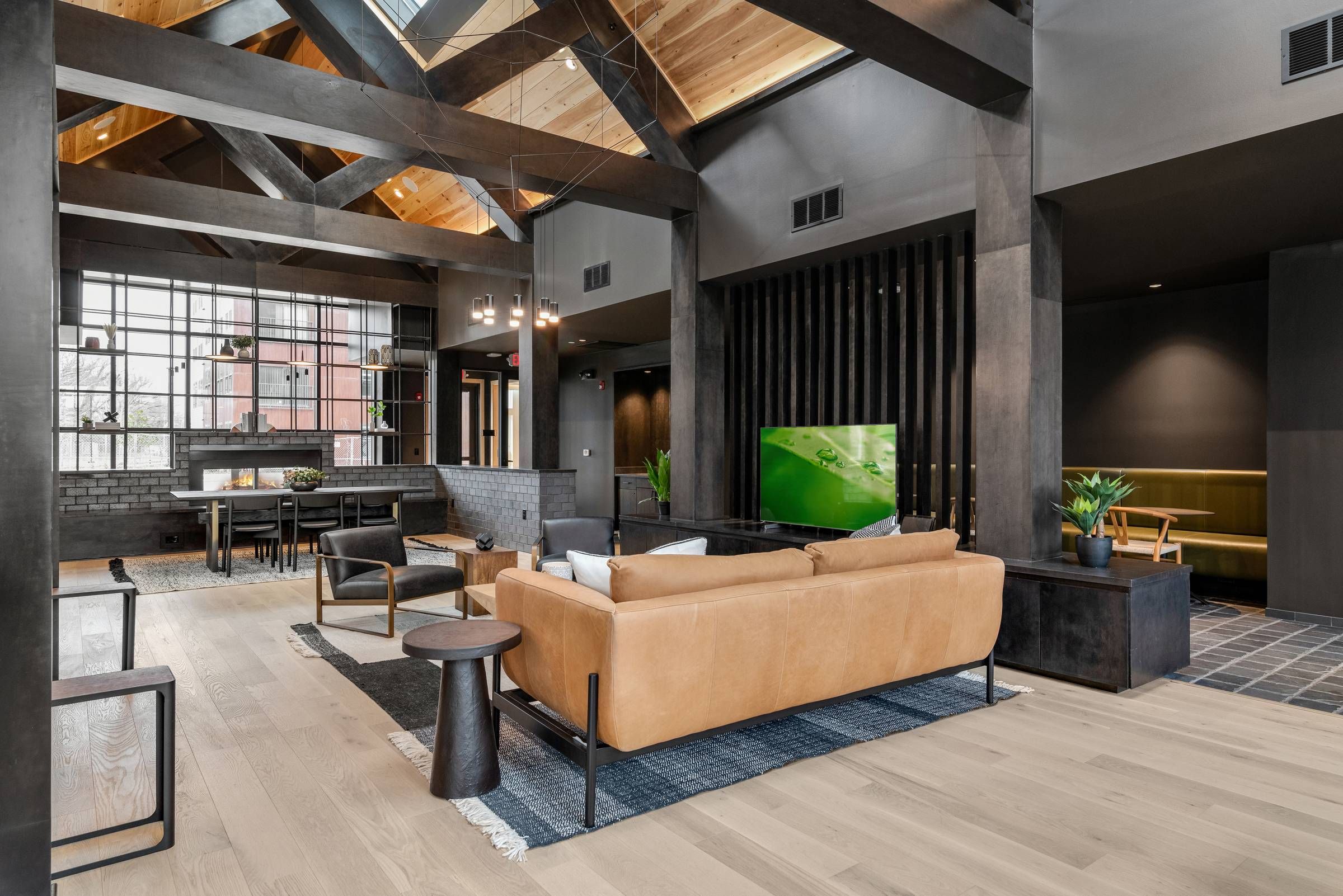 Alta Riverwalk clubhouse lounge area with ample seating and a TV.