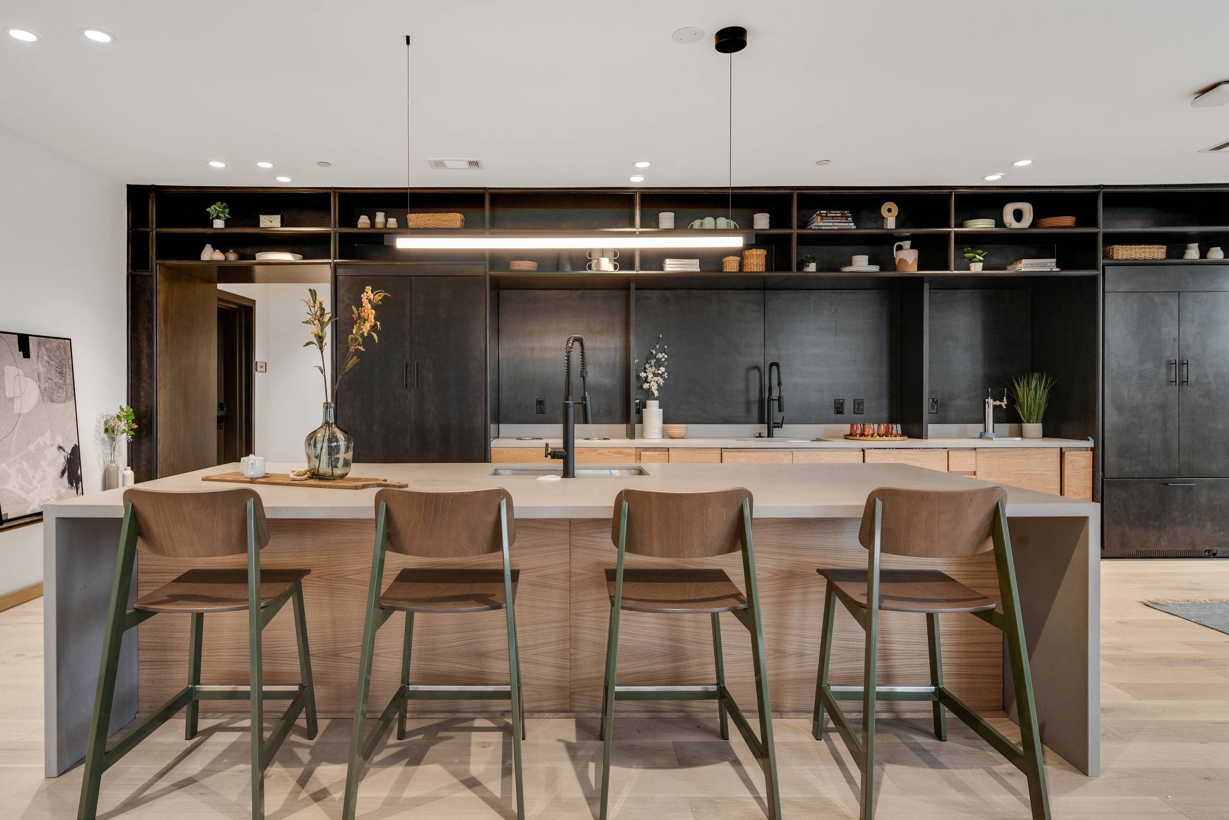 Alta Riverwalk kitchen area with modern architecture and a kitchen island with barstools.