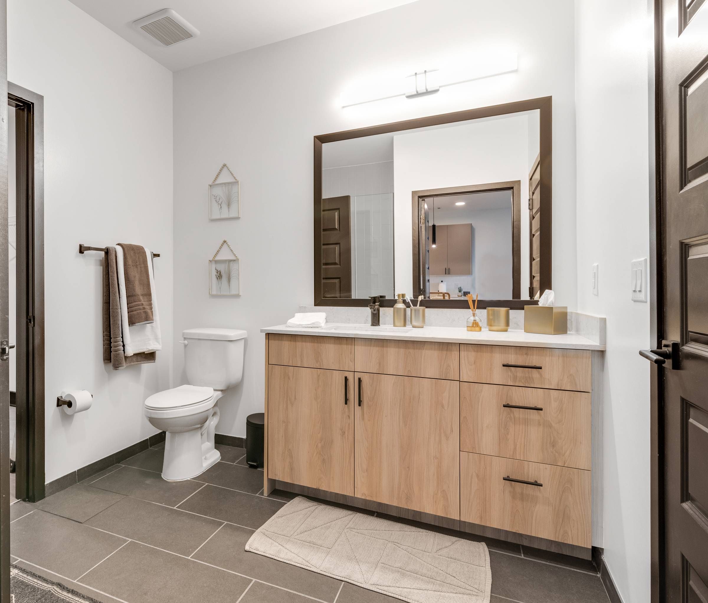 Alta Riverwalk bathroom with ample cabinet space and large mirror.