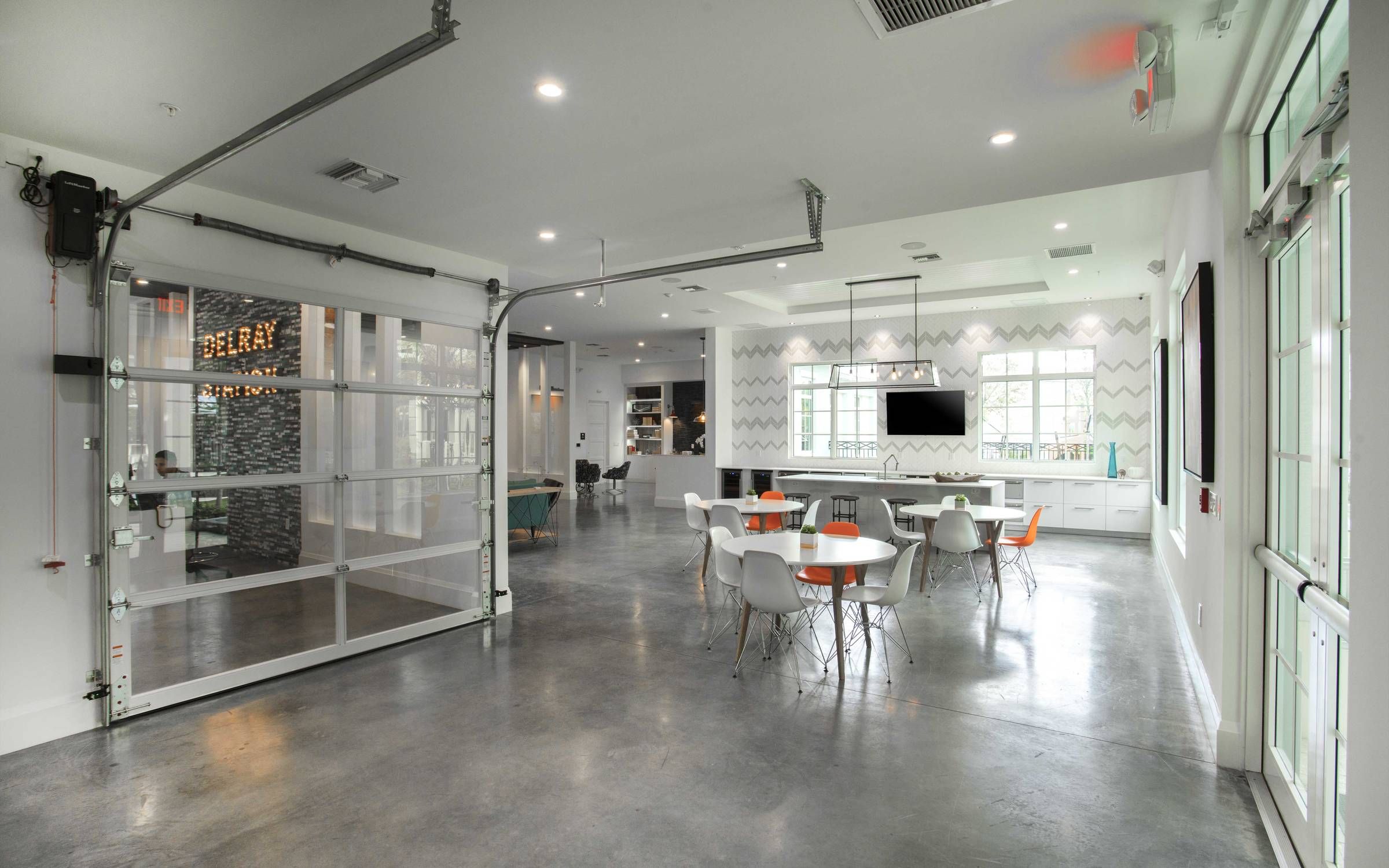 Delray Station communal dining area with dining tables and chairs.
