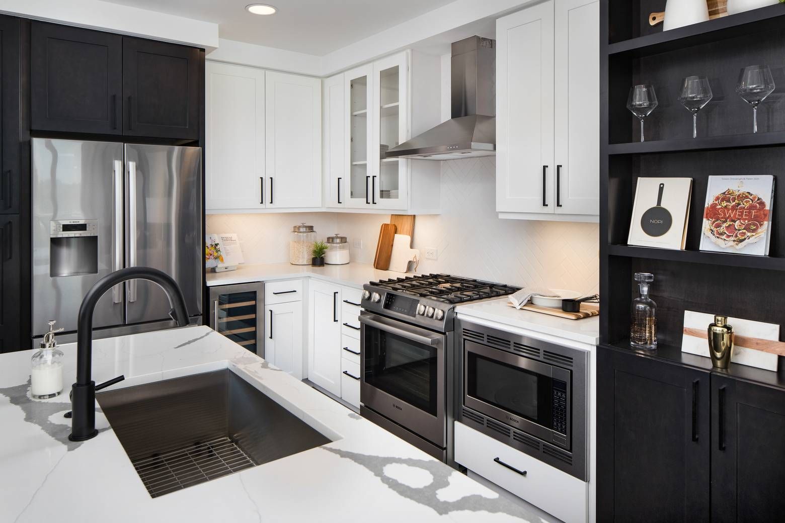 The Huntley kitchen with ample cabinet space, stainless steel appliances, floating kitchen island, and stylish marble countertops.